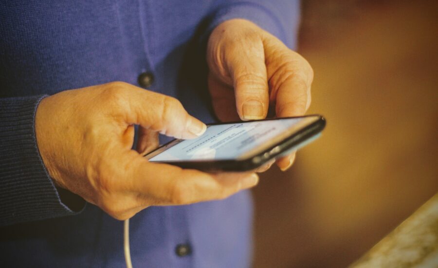 A senior holds their cell phone.